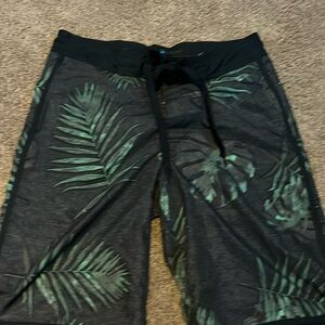 Black with green leaves swim trunks size small.
